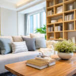 Affordable living room furniture setup with modern sofa, coffee table and bookshelf on a budget