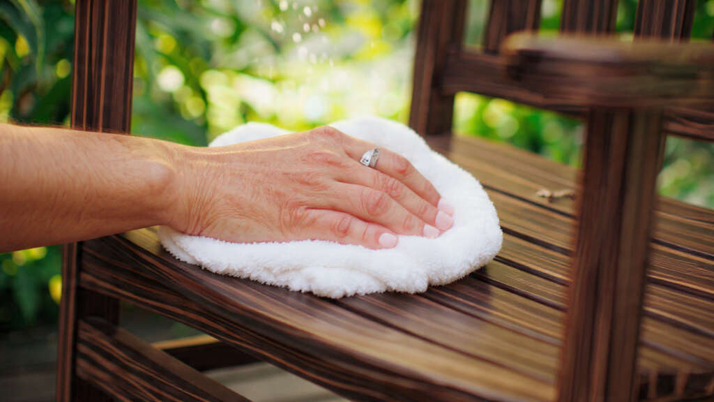 Cleaning Polywood furniture with soap and water for easy maintenance.