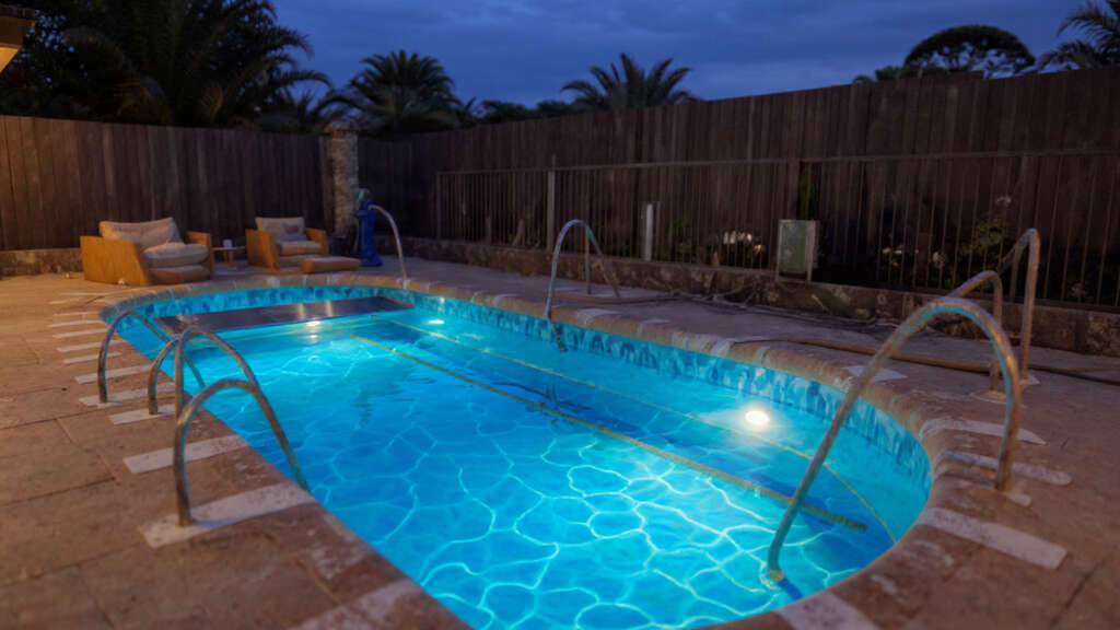 Energy-efficient pool with solar cover and LED lighting