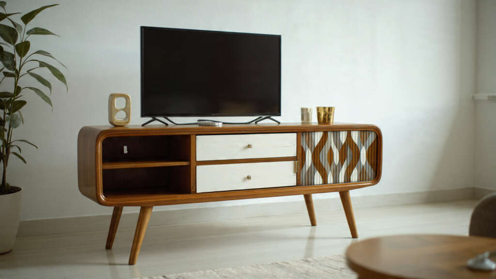 Mid-century modern TV stand in a minimalist living room with wooden finish and open shelving.