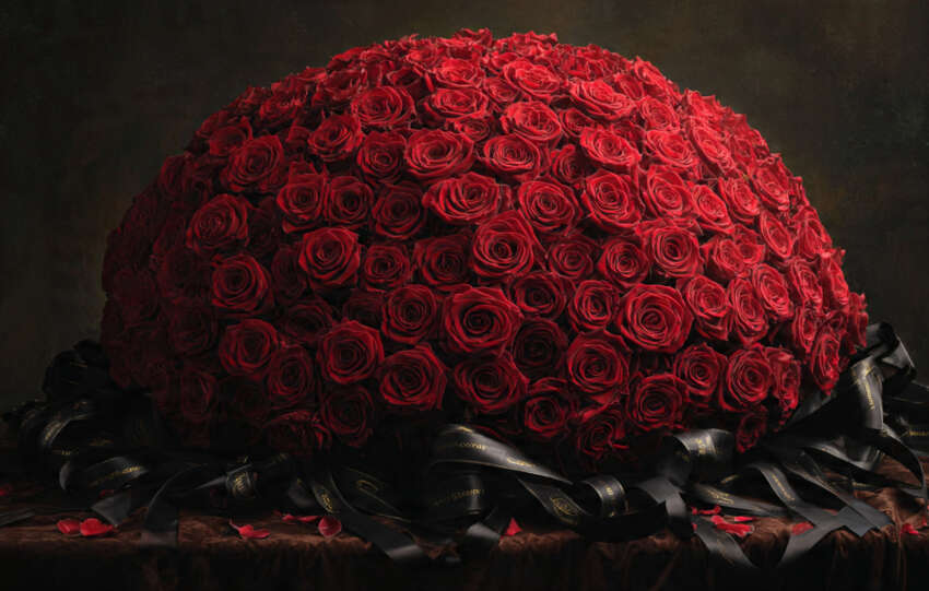 Luxurious 100-red-rose ramo buchon dome bouquet with satin ribbon for dramatic floral impact.