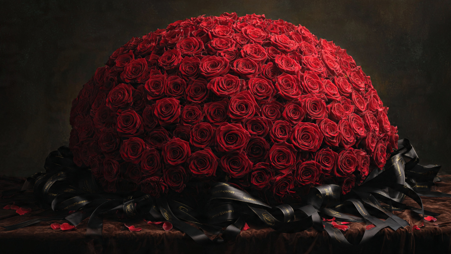 Luxurious 100-red-rose ramo buchon dome bouquet with satin ribbon for dramatic floral impact.